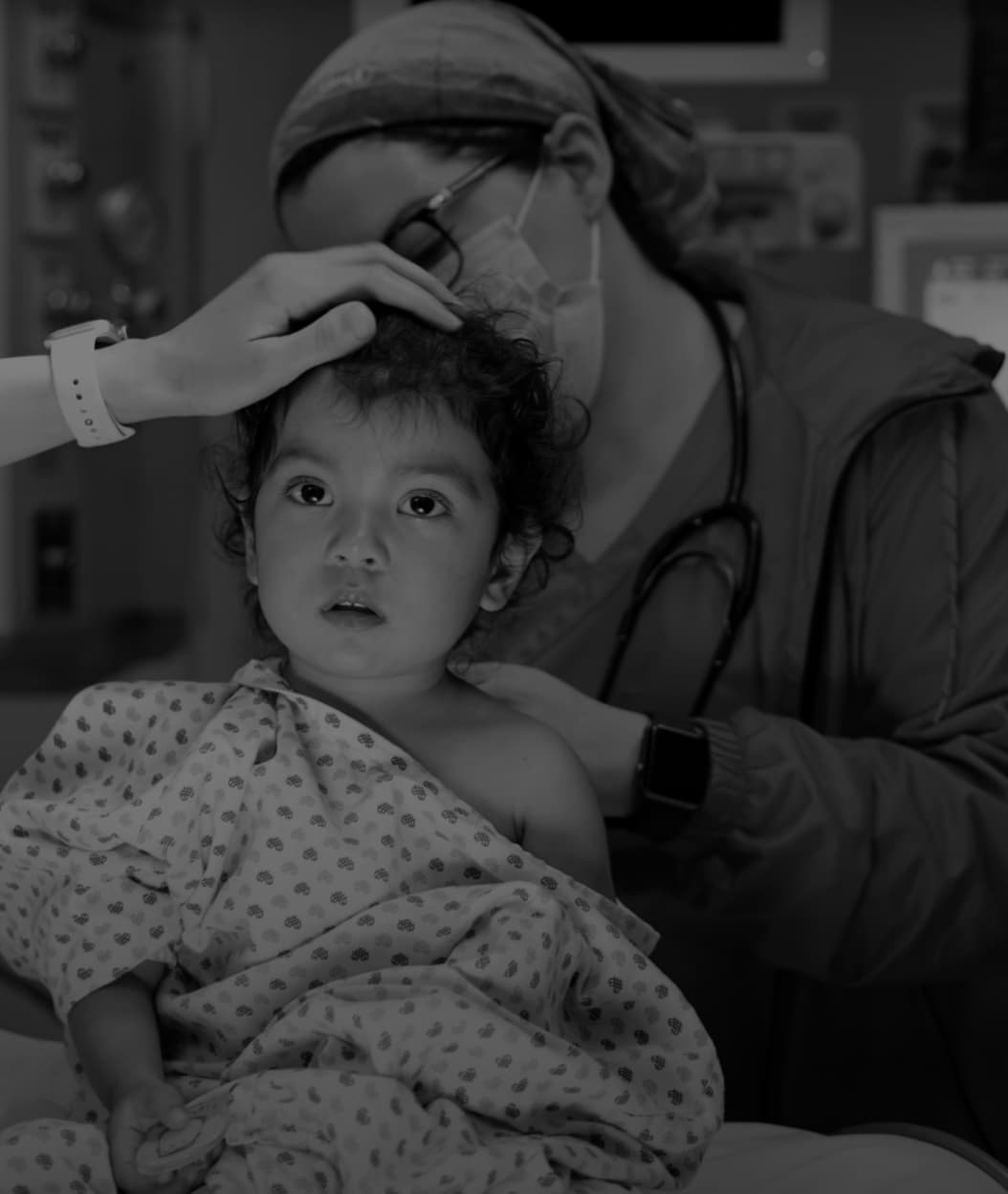 A black and white photo of a kid in procedure