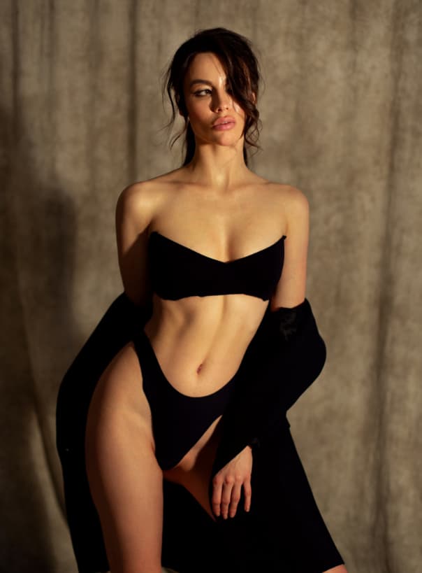 Woman in black lingerie posing