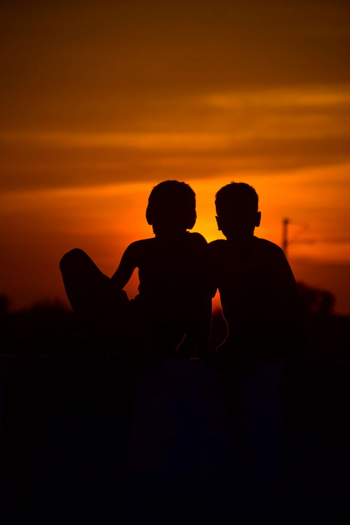 A sunset backdrop with two kids in the photo