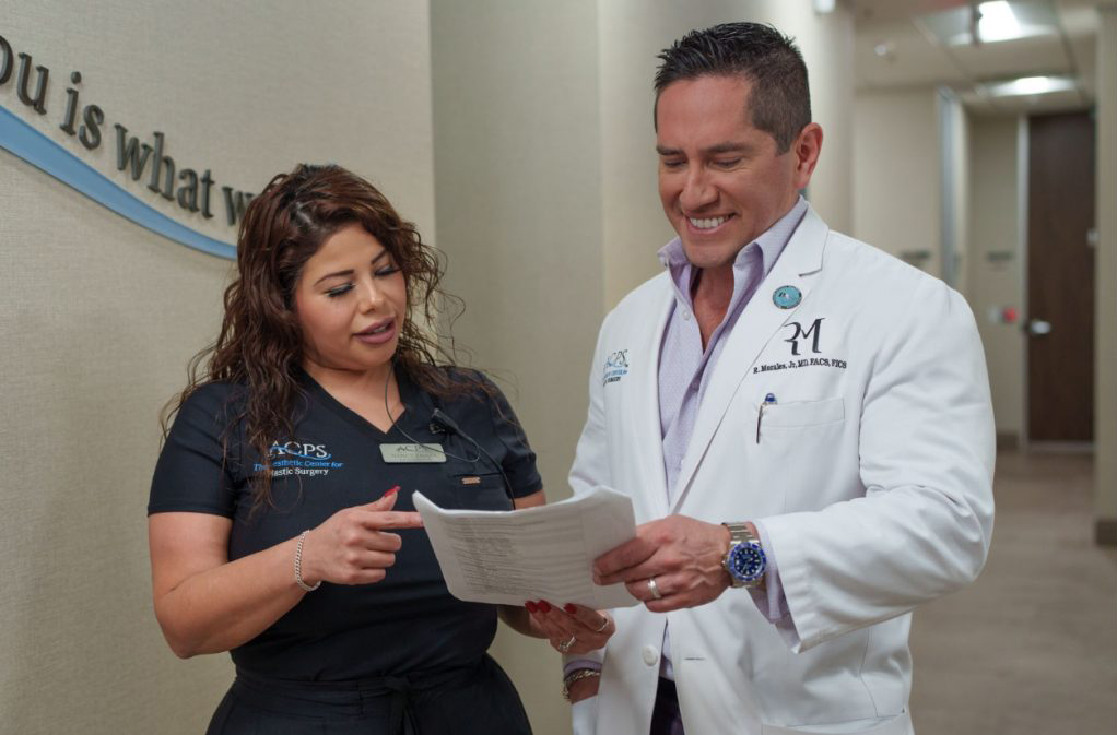 Dr. Morales with Staff taking a look at paperwork joyfully